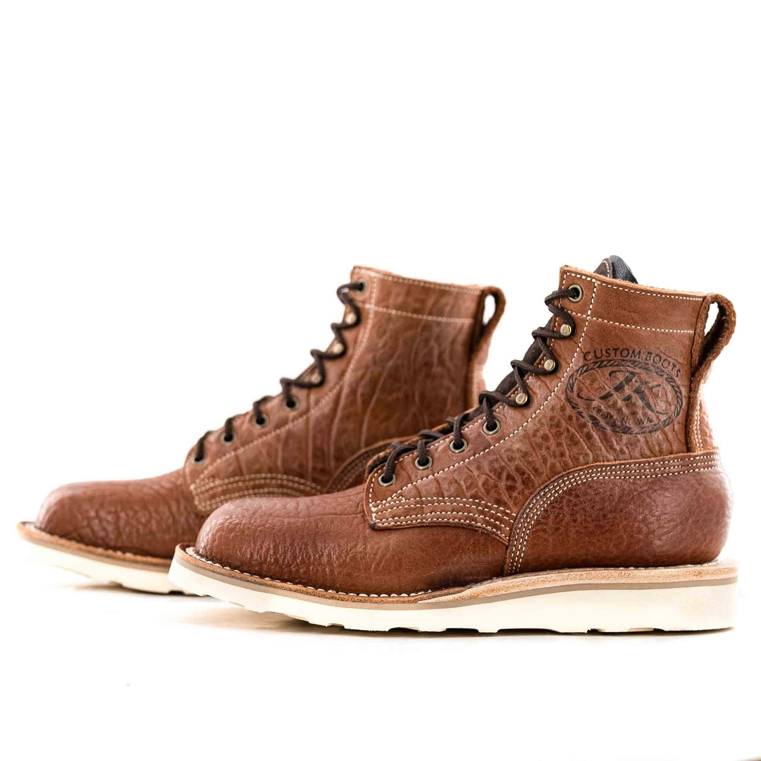 Side view of a pair of Forefront Bison Canyon leather work boots on a white background